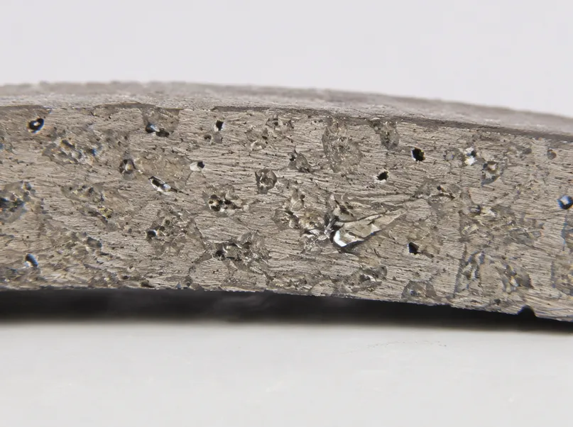 Close-up of diamond segment cross-section showing metal bond matrix with embedded diamond crystals