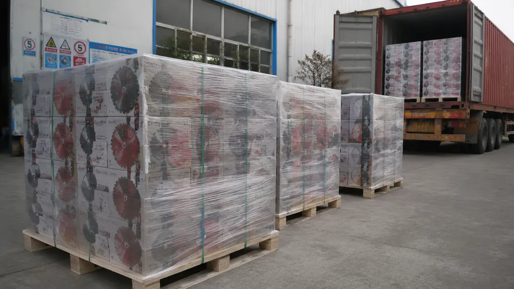 Palletized and shrink-wrapped diamond cutting discs staged for container export at a factory loading area