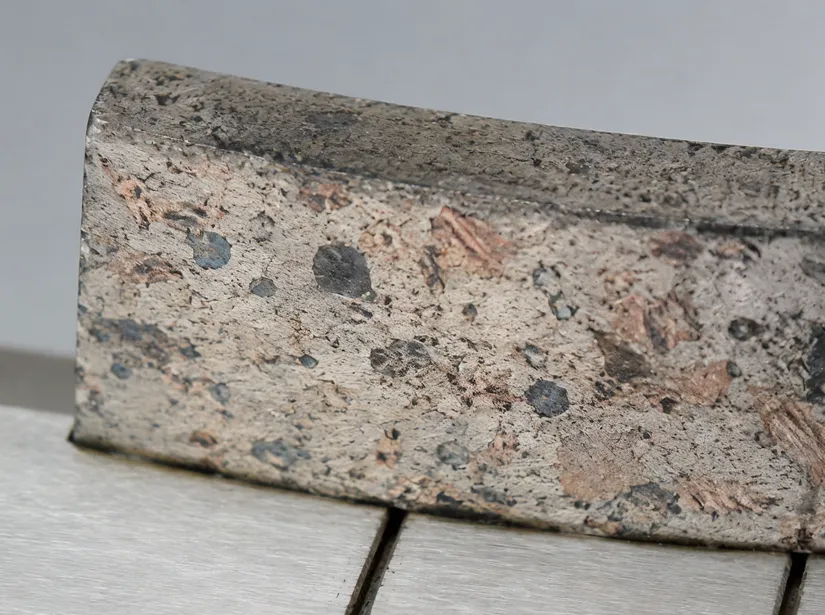 Close-up of iron-cobalt-bronze bond matrix in a concrete diamond cutting disc segment
