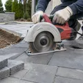 Dry cut blade cutting patio pavers on landscape installation site