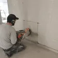 Indoor concrete wall cutting with dry cut diamond blade during renovation