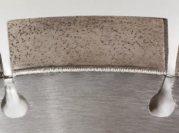 Macro photograph of laser-welded joint between diamond segment and steel core