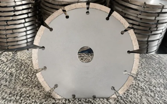 Segmented rim granite diamond cutting disc showing gullets between segments for debris clearance