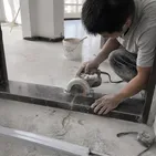 Contractor cutting marble threshold during residential renovation project