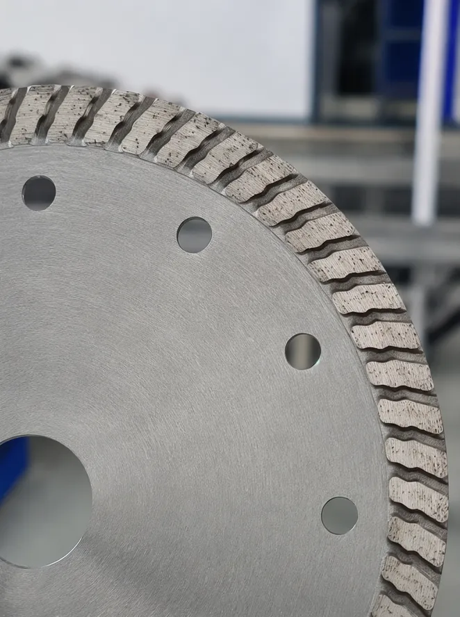 Close-up of turbo rim serration pattern showing wave-shaped notches that create turbulence channels for debris clearance