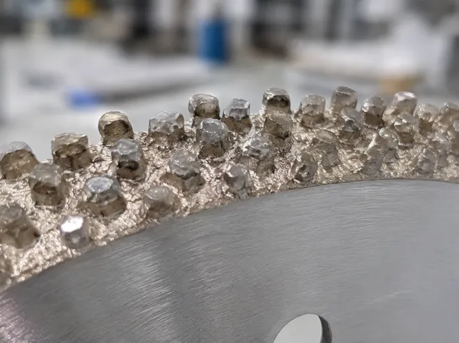 Close-up view of diamond crystals protruding above braze matrix on vacuum brazed blade