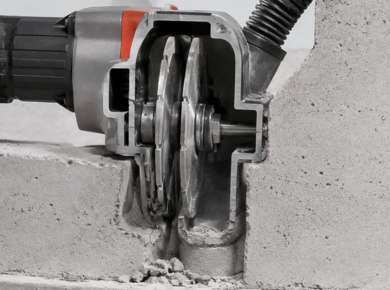 Cross-section showing dual-blade operation in wall chasing machine with confined dust channel