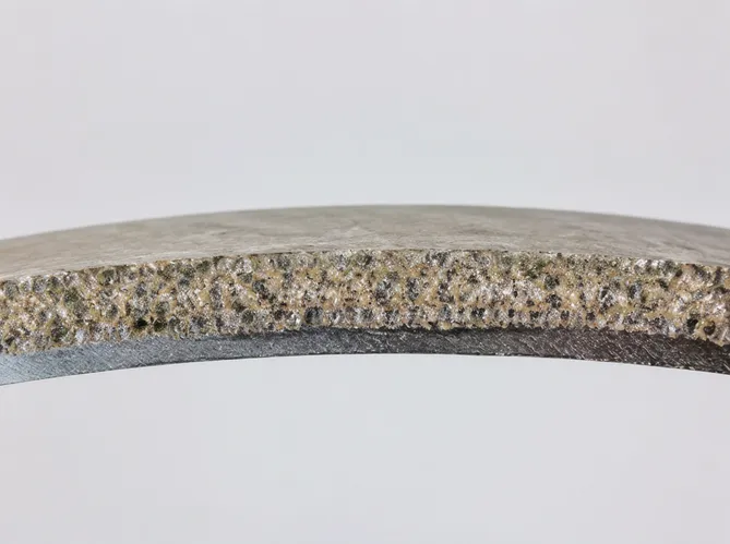 Cross-section view of a continuous rim diamond blade showing sintered bond and diamond grit distribution