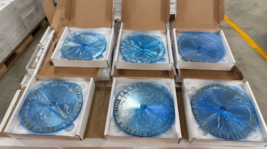 Engineered stone saw blades packed in VCI anti-corrosion film with foam padding inside branded boxes, ready for container shipping
