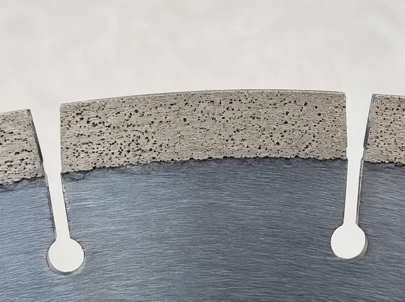 Close-up of CLSEG engineered stone blade segment showing controlled porosity bond matrix