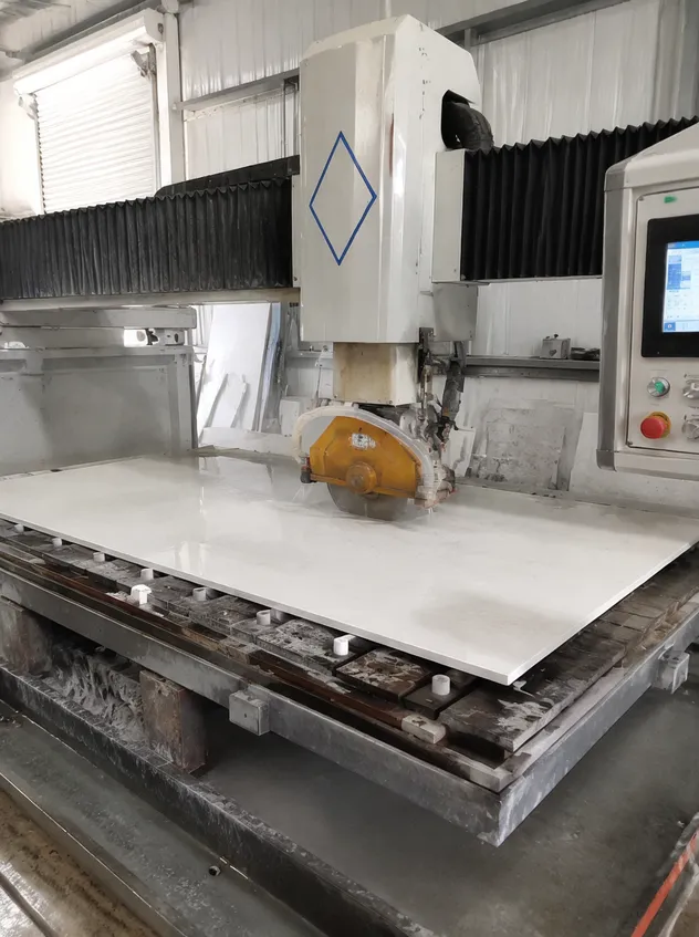 Countertop fabrication shop using bridge saw to cut engineered quartz slab