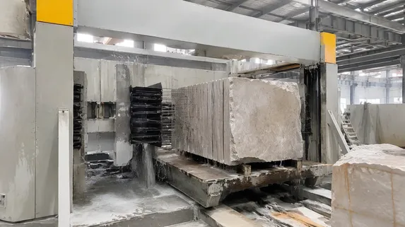 Stone block processing operation cutting slabs for export with multi-blade gang saw frames
