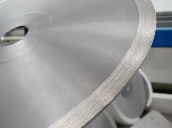 Close-up of continuous-rim marble blade showing flush segment-to-core transition after grinding