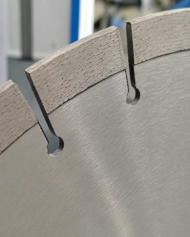 Close-up of segmented diamond blade gullet geometry showing debris channel and segment spacing