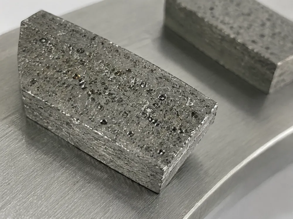 Close-up of diamond blade segment showing bond matrix and exposed diamond crystals