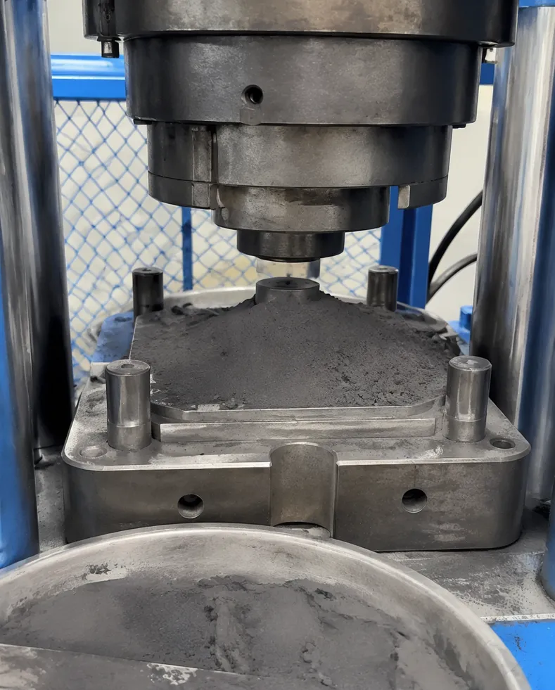 Close-up of diamond segment sintering process showing raw metal bond powder being pressed into segment blanks